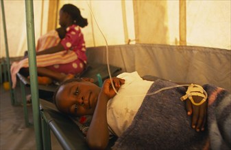 KENYA, Nairobi, Child on bed in emergency Cholera treatment tent in the Kisumu Ndogo slum area