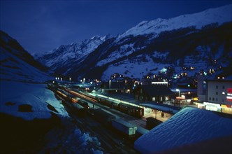 SWITZERLAND, Landscape, Ski resort chalets and train station in snow covered mountain landscape at