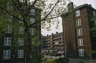 ENGLAND, London, Greenwich council housing with trees and public garden.