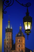 POLAND, Krakow, "Detail of St Mary's Church in Rynek Glowny, Night time with lit lamp with