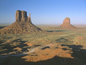 USA, Arizona, Monument Valley, Rock formations surrounded by desert in evening light