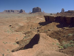 USA, Arizona, Monument Valley, A figure on horseback in the distance on John Ford Point
