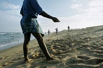 INDIA, Tamil Nadu, Auroville Beach, South Indian fishermen return to beach-casting 5 weeks after