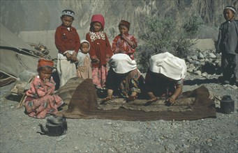 AFGHANISTAN, People, Kirghiz women making felt mats watched by children.