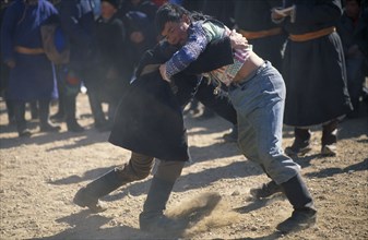 MONGOLIA, Bayan Olgii Province, Festivals, Kazakh nomad wrestlers at New Year festivities.