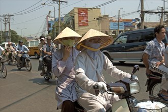 VIETNAM, South, Ho Chi Minh City, Monks in conical hats riding a a motorbike