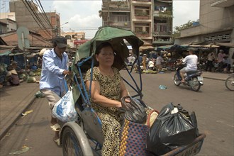 VIETNAM, South, Ho Chi Minh City, Woman riding in a cyclo
