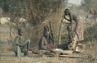 SUDAN, Agriculture, Dinka women pounding millet.