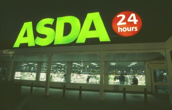 SHOPPING, Supermarkets, Asda twenty four hour supermarket. Large sign illuminated at night.