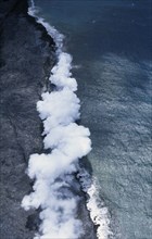 USA, Hawaii, Big Island, Steam cloud rising where lava enters the sea on the south east Puna Coast