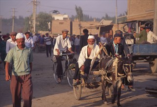 CHINA, Xinjiang Province, Kashgar,  Tajik men on donkey cart