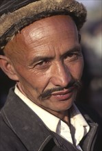 CHINA, Xinjiang Province, Kashgar,  Head and shoulders portrait of Tajik man