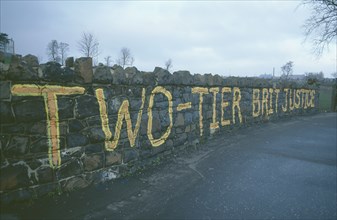 IRELAND, North, Belfast, Falls Road. Beechmount Area. Anti British grafitti on a wall saying Two