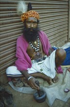 INDIA, Goa, Margao, Herbalist and medicine man selling alternative cures.