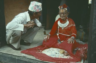 NEPAL, Patan, Man consulting an oracle astrologer