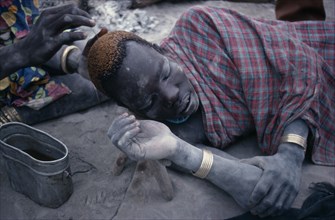 SUDAN, People, Men, Dinka man having his hair dyed using cattle urine.