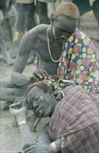 SUDAN, People, Dinka man having his hair dyed using cattle urine.