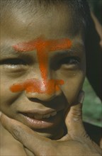 ECUADOR, People, Portrait of Auca Indian with red achote paint decorating face.