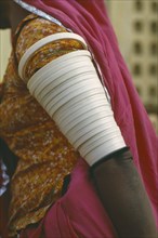 INDIA, Rajasthan, People, Cropped view of woman wearing multiple armbands.