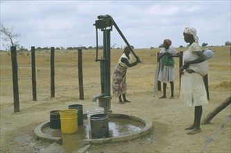 ZIMBABWE, People, Women collecting water from hand pump.
