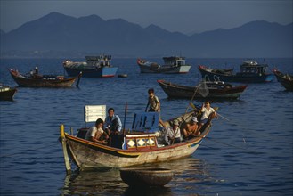 VIETNAM, Nha Trang, Fishing boats at first light off the Southern end of the beach.