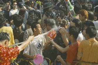 THAILAND, Bangkok, "Crowd having a water fight,  celebrating the Songkhran Festival. Thai New Year,