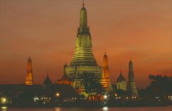THAILAND, Bangkok, "Wat Arun, The Temple of  Dawn, on the bank of the Chao Phraya River, lit up at