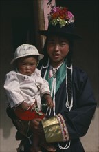 CHINA, Qinghai Province, Huzhu District, Tu minority Tibetan Buddhist mother and daughter.