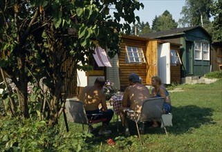 CZECH REPUBLIC, People, Cernosice Holiday Homes. Elderly couples sitting around a table on the