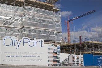 ENGLAND, East Sussex, Brighton, Housing construction site with advertising billboard on view next