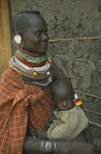 KENYA, Great Rift Valley, Kakuma, Anna Naguie with her baby in Kalobeyei camp for destitute Turkana