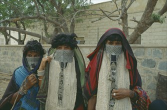 ERITREA, Massawa, Portrait of three Rashaida nomad women wearing embroidered veils and silver