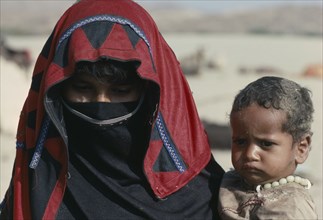 SUDAN, South Tokur, Portrait of veiled Rashaida nomad woman and child.  Originally from Saudi