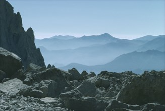 SPAIN, Asturias, Picos de Europa, View over misty mountaineous landscape.