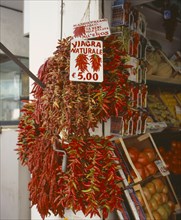 ITALY, Campania, Amalfi, "Via Genova, Main Street. Dried Chilli peppers hanging outside a shop.