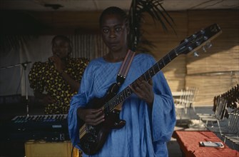 CONGO, Kinshasa, Woman playing electric guitar.