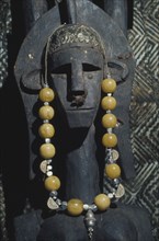 KENYA, Craft, Carved mask hung with necklace.