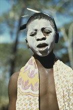 TANZANIA, Tribal People, Portrait of young girl with her face covered in ritual whitening for
