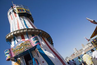 ENGLAND, East Sussex, Brighton, The Helter Skelter ride on Brighton Pier with tourists walking past