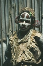 KENYA, Tribal People, Portrait of Kikuyu tribeswoman with painted face and wearing head dress for