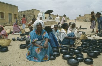 ERITREA, Decamare, Women selling black pottery at market.