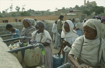 ERITREA, Seraye, Women filling containers at water point.