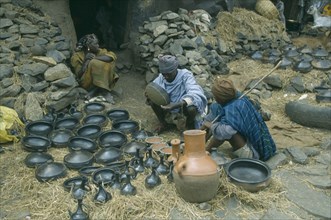 ETHIOPIA, Gondar, Black pottery for sale at market.