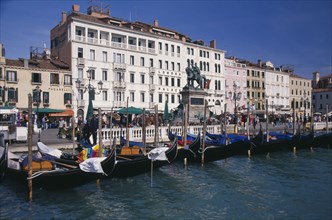 ITALY, Veneto, Venice, Gondolas moored against the Riva degli Schiavoni with the Londra Palace