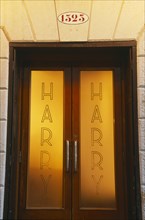 ITALY, Veneto, Venice, Door of Harry’s Bar with name etched on the frosted glass.