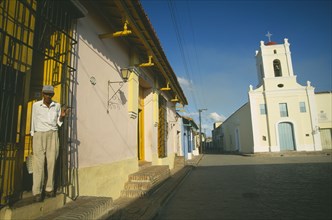 CUBA, Camaguey, Pastel coloured houses lining Playa de San Juan de Dios and Iglesia San Juan de