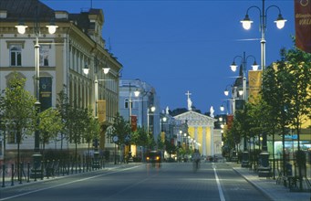 LITHUANIA, Vilnius, Gedimino shopping street lined with illuminated street lights leading to the