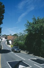 ENGLAND, Kent, Cranbrook, Car traveling towards traffic calming speed ramps on road.