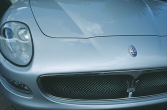 TRANSPORT, Road, Cars, Detail of silver Maserati with emblem and front light.