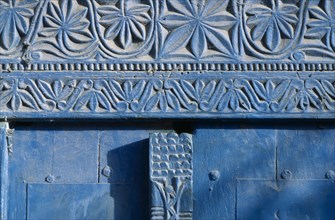 SOMALIA, Mogadishu, Detail of blue painted doorway with carved plant motif.